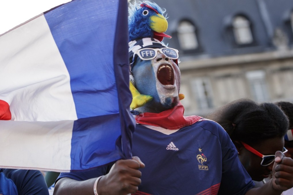 A French man cheers on Les Bleus in Paris during the side’s the semi-final win over Belgium. Photo: EPA