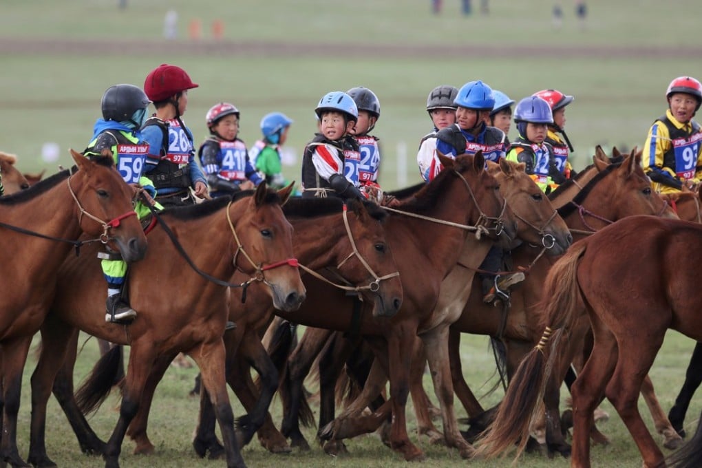 Child jockeys riding horses head to the start line for the Soyolon horse race at the Mongolian Naadam festival. Photo: Reuters