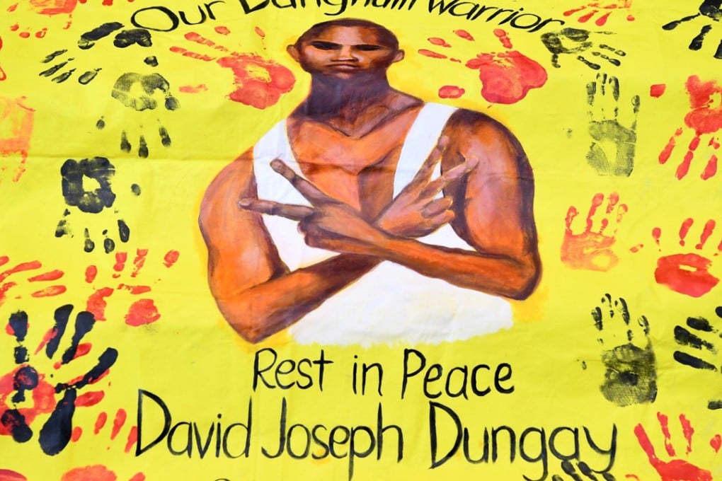 A banner featuring an image of David Dungay lies on the steps of Downing Centre Court in Sydney, Australia on July 16, 2018. Dungay died in custody at Long Bay Correctional Centre in December 2016 after he was held face down on the floor and sedated. Photo: EPA