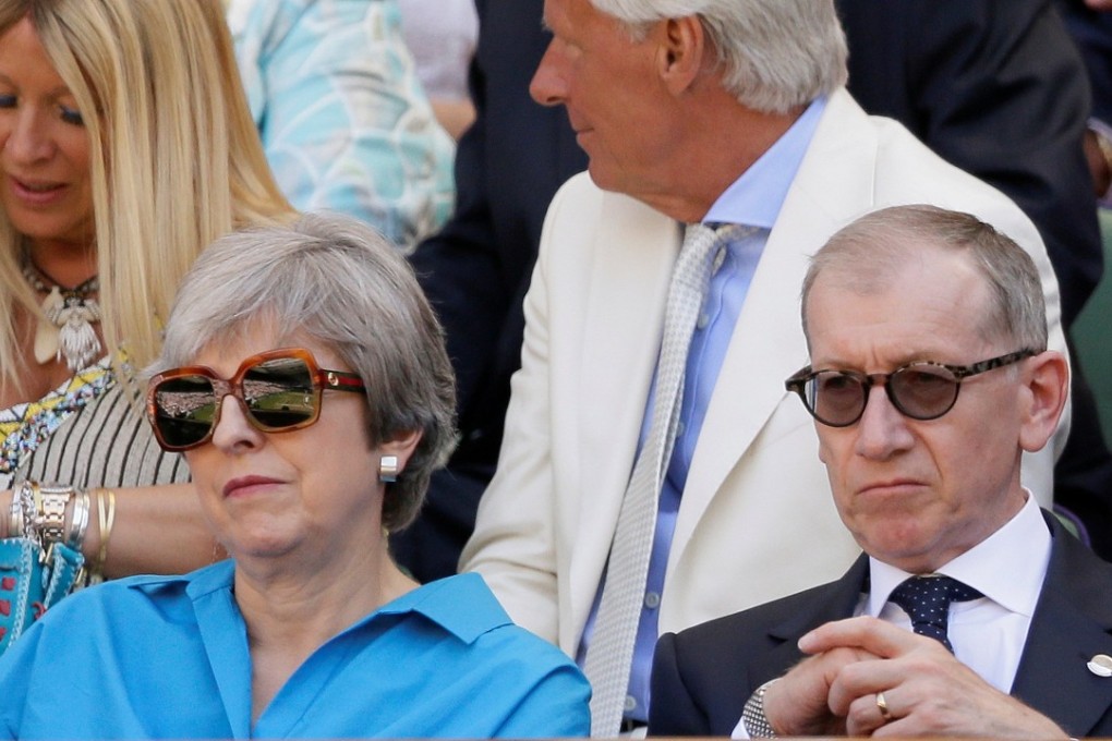 Britain's Prime Minister Theresa May and her husband Philip sit in the Royal Box ahead of Serbia's Novak Djokovic men's singles final against South Africa's Kevin Anderson on Sunday. Photo: Reuters