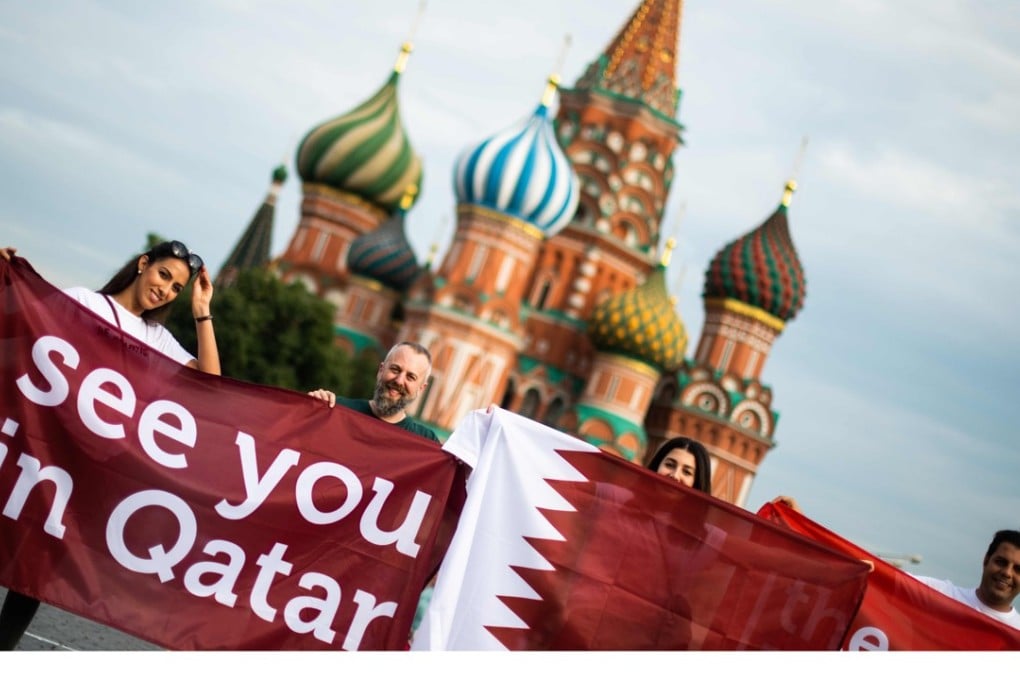 A group of people display a banner reading ‘See you in Qatar’ in reference to the Qatar 2022 World Cup at Red Square in Moscow. Photo: AFP
