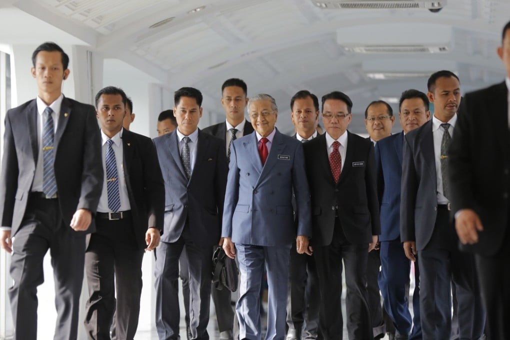 Malaysian Prime Minister Mahathir Mohamad, centre, walks to the parliament hall in Kuala Lumpur, Malaysia. Photo: AP