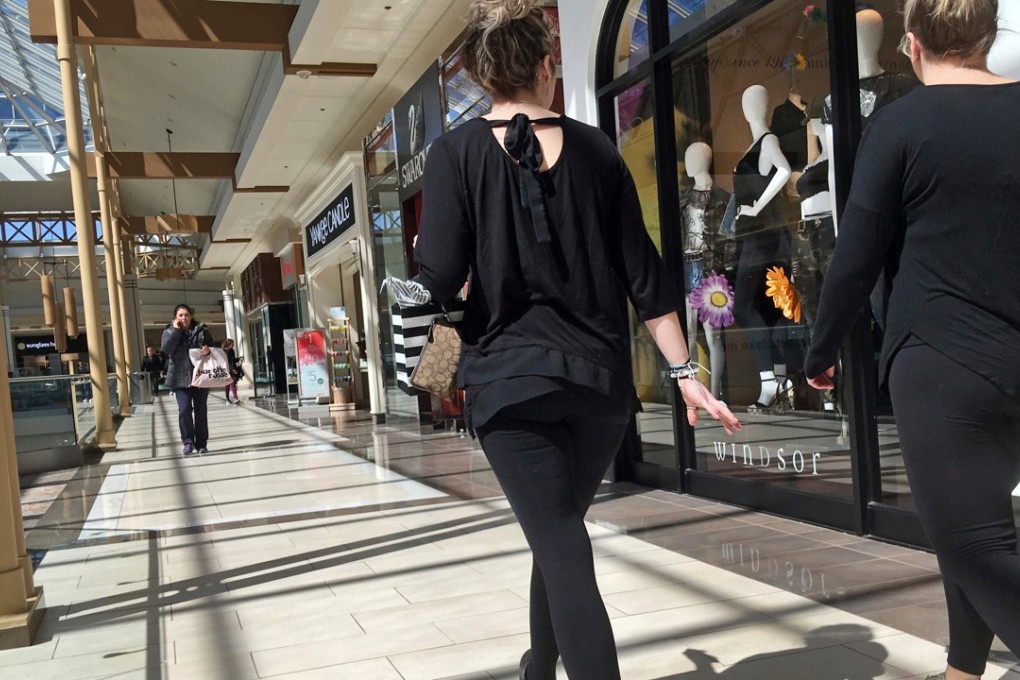FILE- In this April 9, 2018, file photo, shoppers walk in a mall in Salem, N.H. As Amazon gears up for its Prime Day promotion, other big-name retailers like Macy’s and eBay are launching deals and sales of their own. But small businesses, including those that don’t sell much online, shouldn’t sit on the sidelines. (AP Photo/Elise Amendola, File)