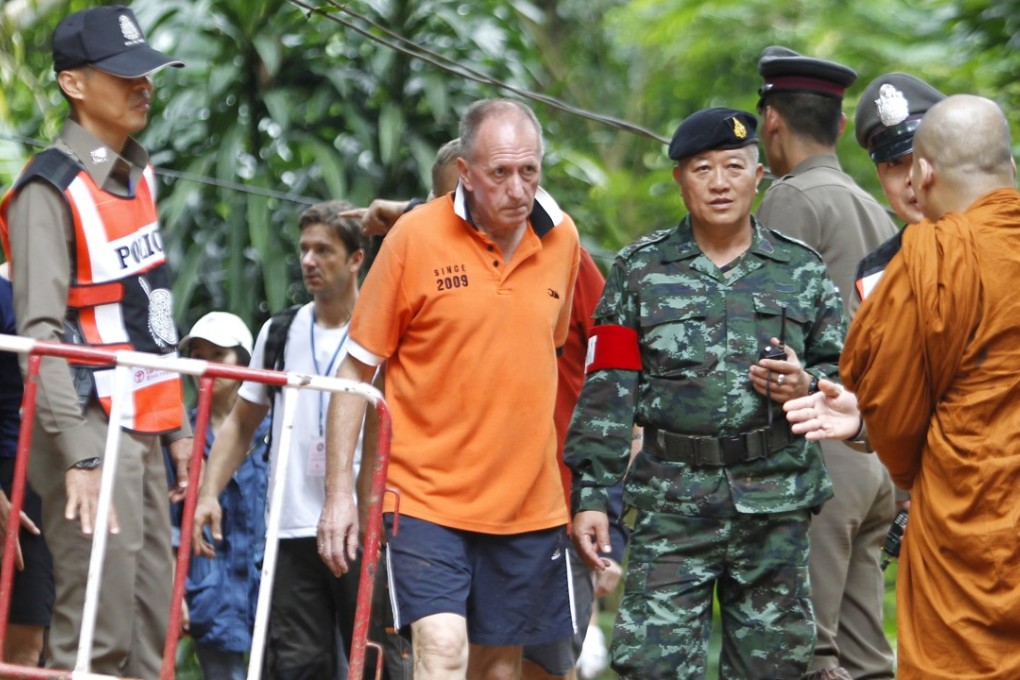 British cave diver Vern Unsworth (centre) walks next to a Thai soldier and policemen during the rescue operations for the Wild Boars soccer team at the Tham Luang cave in Thailand on June 30. Photo: EPA