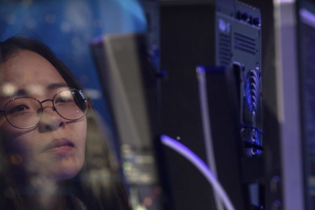 A staff member is reflected in the monitor of a computer as it participates in the CHAIN Cup in Beijing, June 30, 2018. A computer running AI software defeated two teams of human doctors in accurately recognising maladies in magnetic resonance images. Photo: AP
