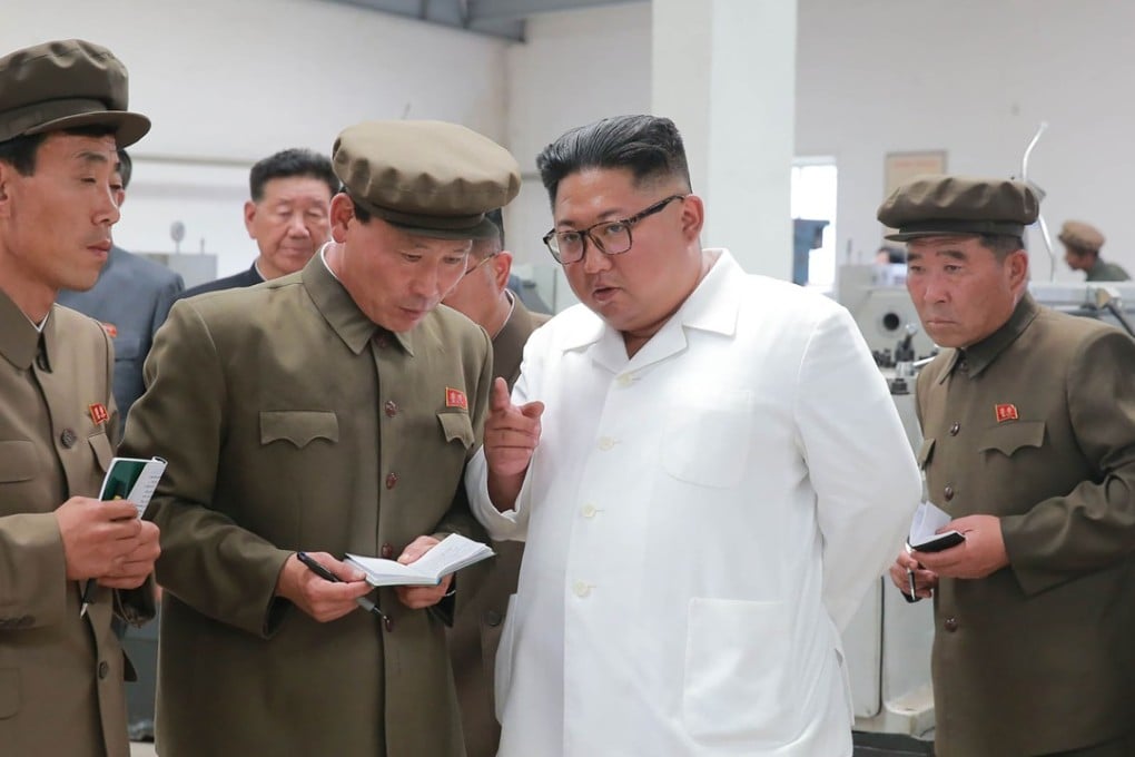 North Korean leader Kim Jong-un (second right) visits a machine factory in this undated photograph. Photo: AFP