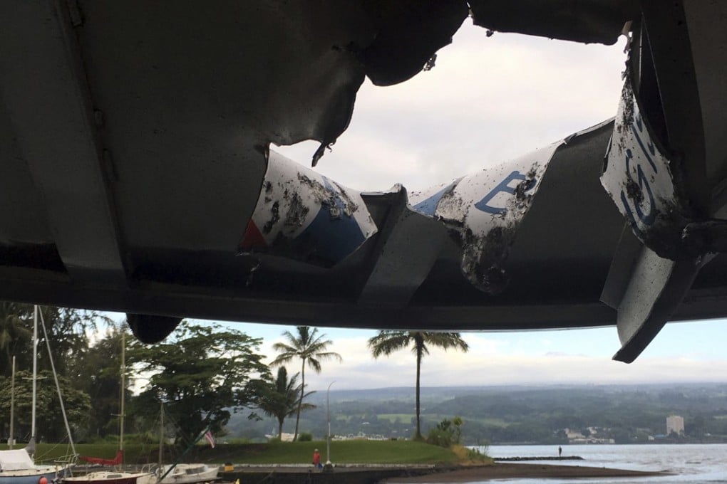 This photo provided by the Hawaii Department of Land and Natural Resources shows damage to the roof of a tour boat caused by a lava bomb from the Kilauea volcano. Photo: AP