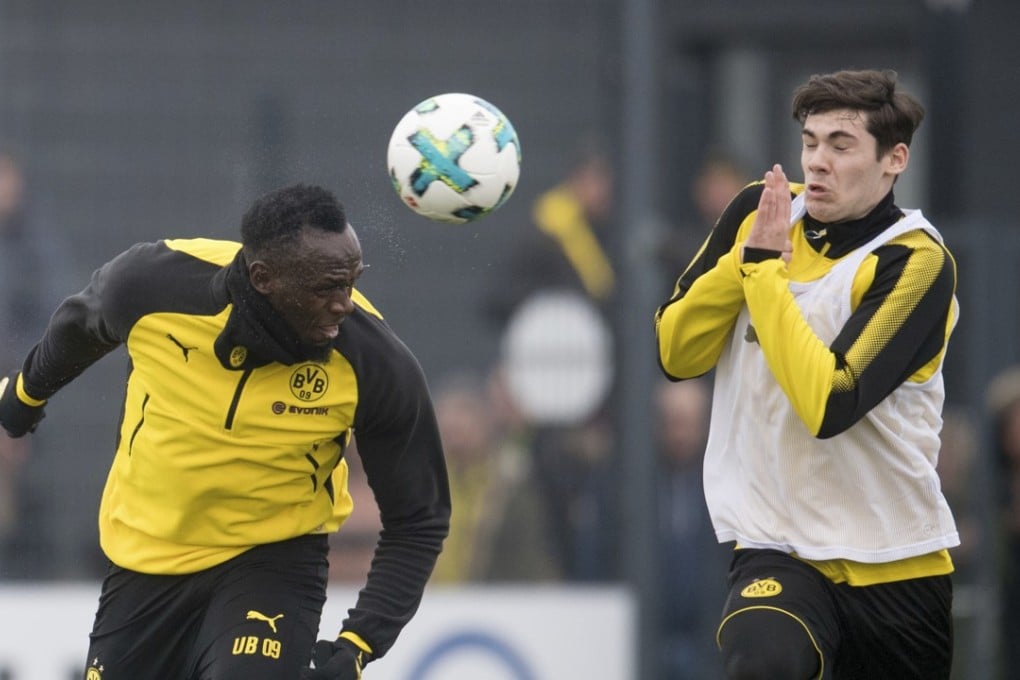Jamaica's former sprinter Usain Bolt heads the ball in a Borussia Dortmund training session. Photo: AP