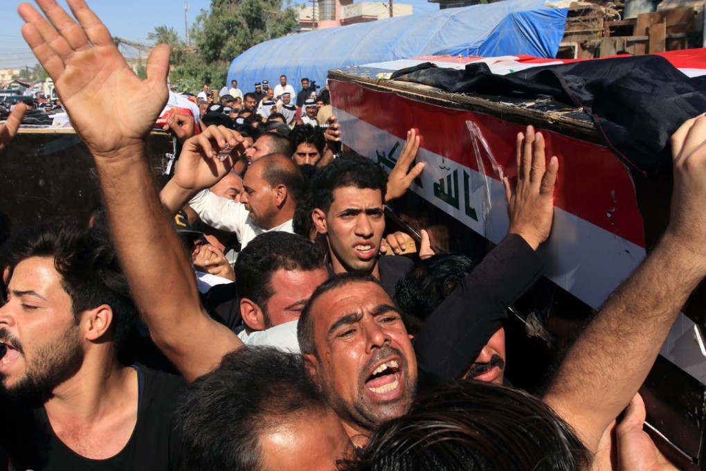 Iraqis carry the coffin of a man who was kidnapped and then executed by the Islamic state group in Karbala city, southern Iraq, on June 28. Photo: EPA