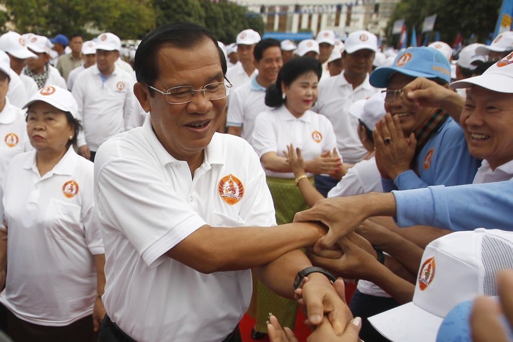 Cambodian Prime Minister Hun Sen greets supporters at a campaign rally on July 7. His Cambodian People’s Party is expected to sweep the polls after the government dissolved the main opposition party. The Cambodian strongman is at the peak of a reign that began in 1985. Photo: AP