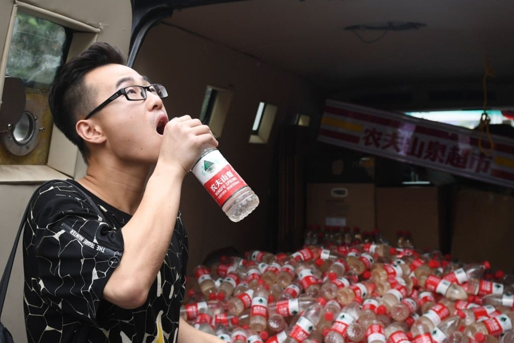 One man was brave enough to sample the dirty water. Photo: AFP