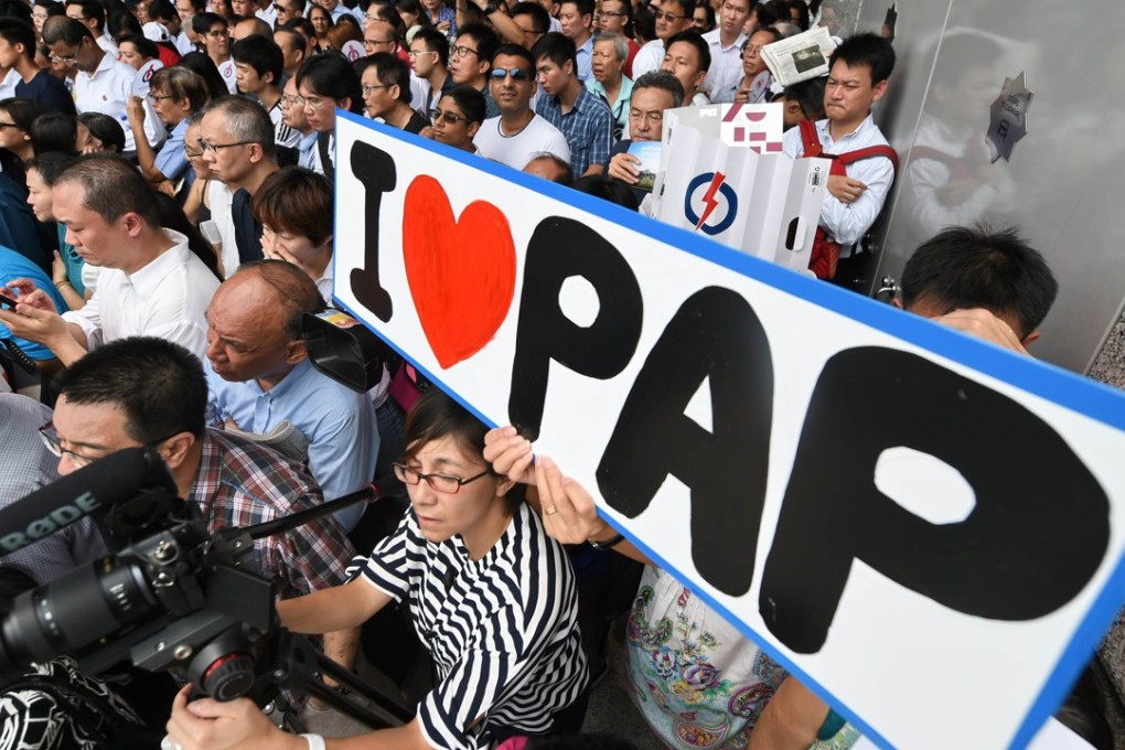Supporters and office workers listen to Singapore’s Prime Minister Lee Hsien Loong, from the ruling People’s Action Party, as he addresses a rally on September 8, 2015, ahead of general elections in the city state. Photo: AFP