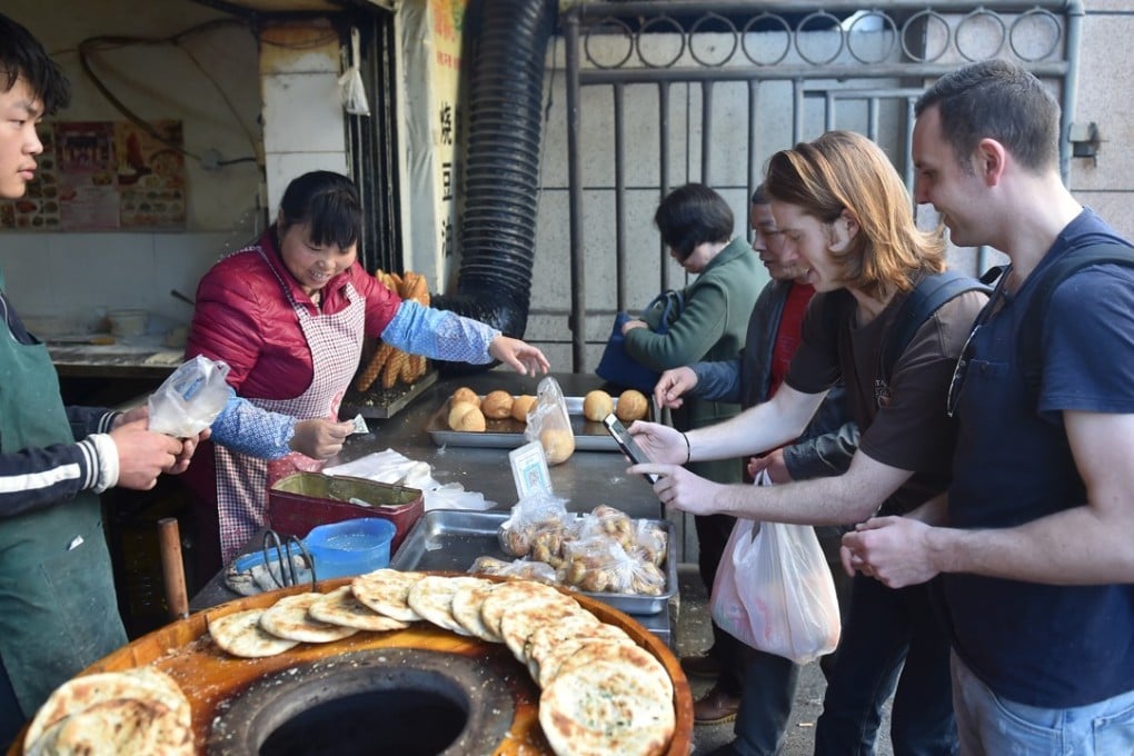 Wide adoption of mobile payment by China’s small businesses have lifted transaction volume to record levels. Photo: Xinhua