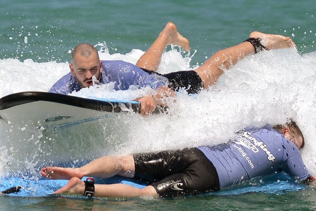This file photo taken on February 24, 2016 shows people surfing on Bondi Beach in Sydney. A proposal to ban surfing on most of Australia's iconic Bondi Beach has triggered anger among the local boardriding community on July 18, 2018. Photo: AFP