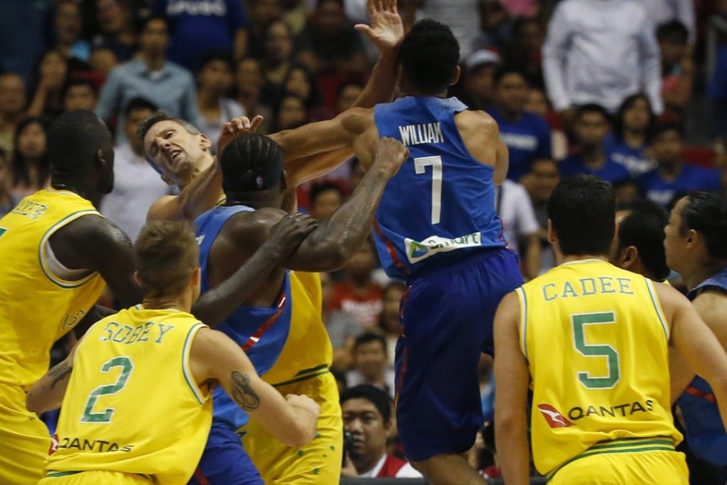The Philippines’ Jason William jumps to hit Australia’s Daniel Kickert as others rush to get involved in the brawl. Photo: AP
