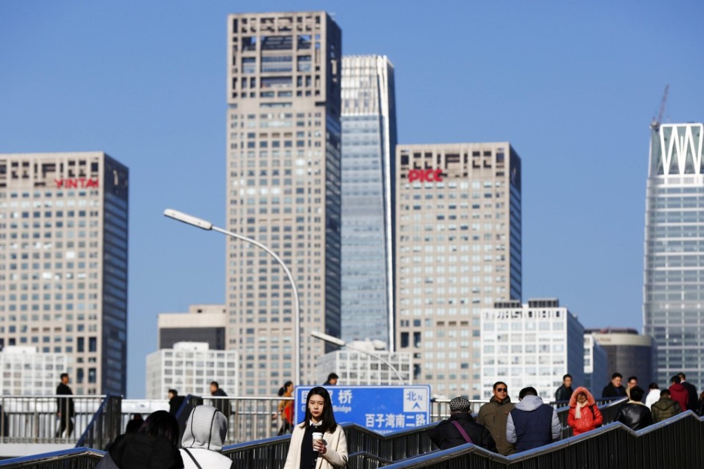 People walk along an overpass in Beijing. China’s bond market is marching to the beat of a different drummer – the fact that it’s not moving in lockstep with other markets provides investors with diversification and a relatively safe haven. Photo: EPA