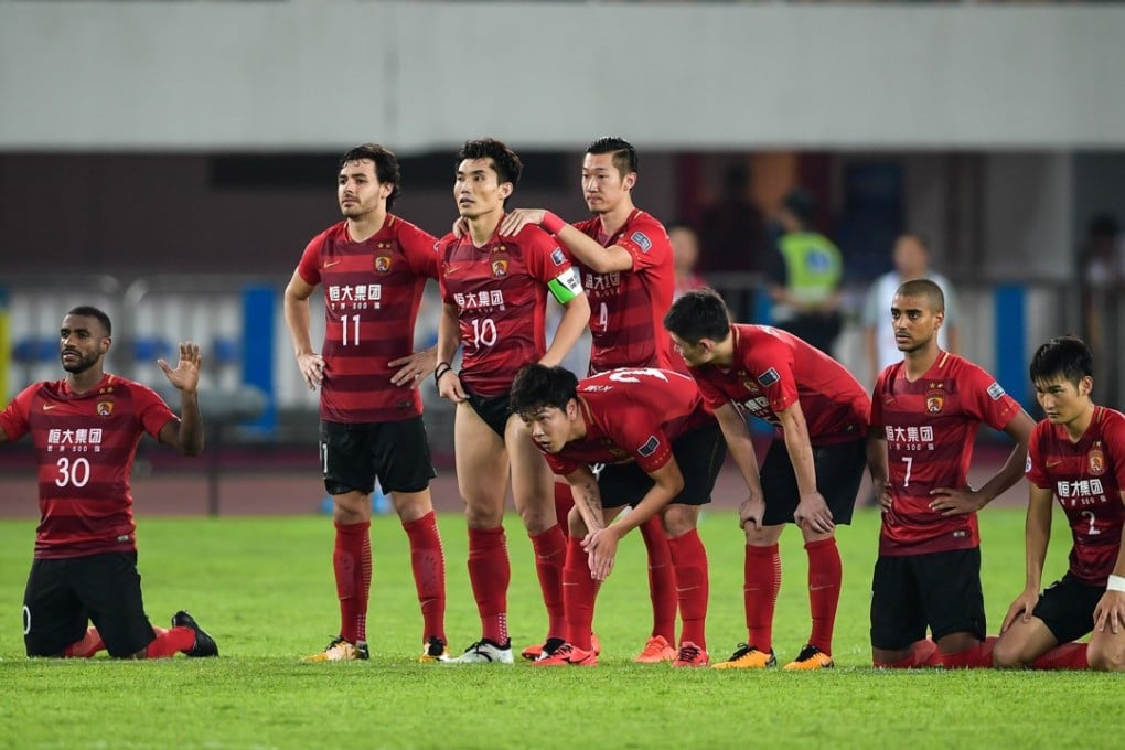 The players of Guangzhou Evergrande, a team in the Chinese Super League, take a moment after losing their AFC Champions League quarter-final match against Shanghai SIPG, in Guangzhou last year. To excel at the game, China must first cultivate a full-fledged football culture. Photo: AFP