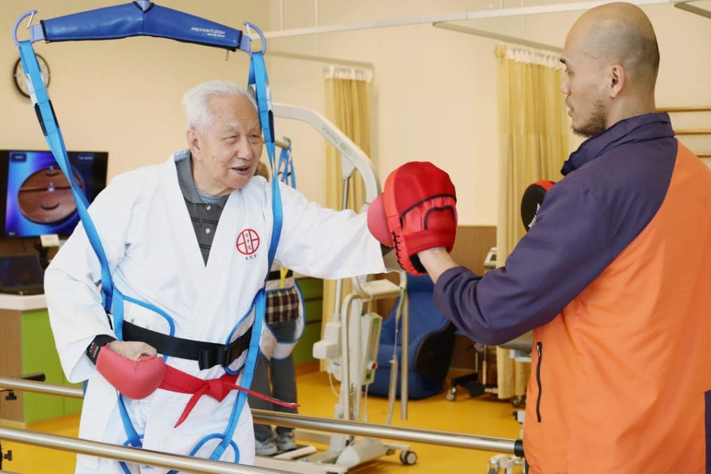 Physiotherapist Joseph Tang Wing-yip works with an elderly man at the TWGHs Jockey Club Sunshine Complex for the Elderly in Wong Chuk Hang. Photo: Nora Tam