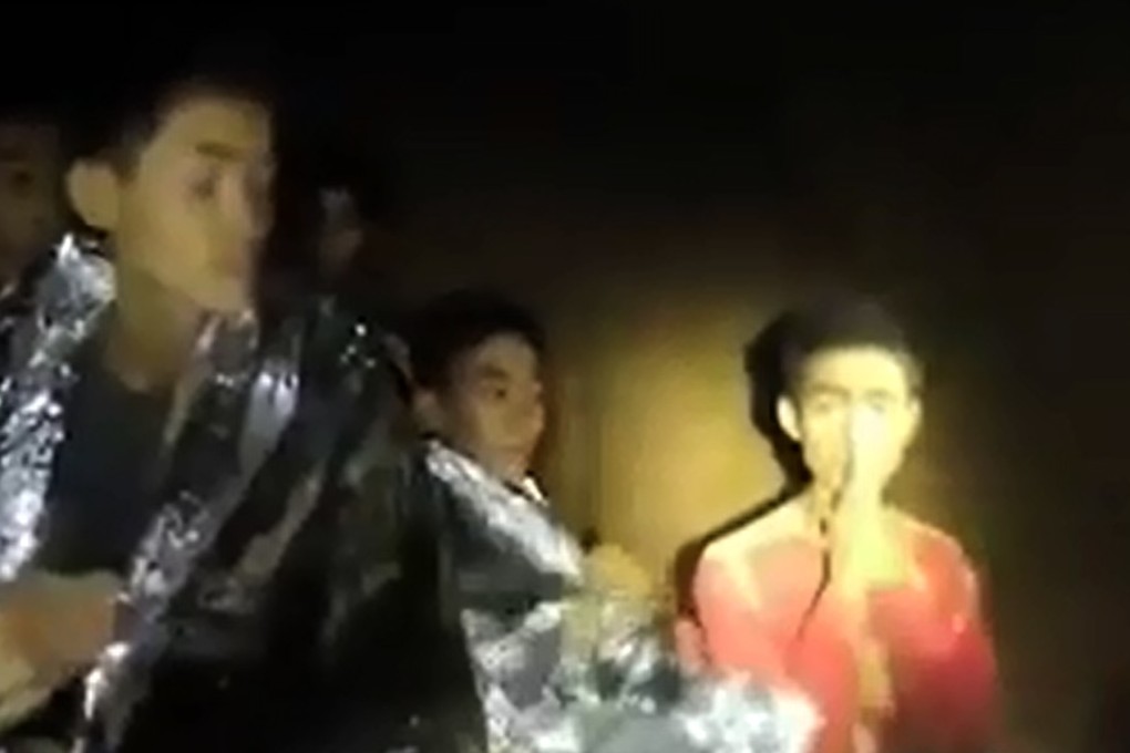 The multilingual Adul Sam-on (right) in the Tham Luang cave. Picture: AFP