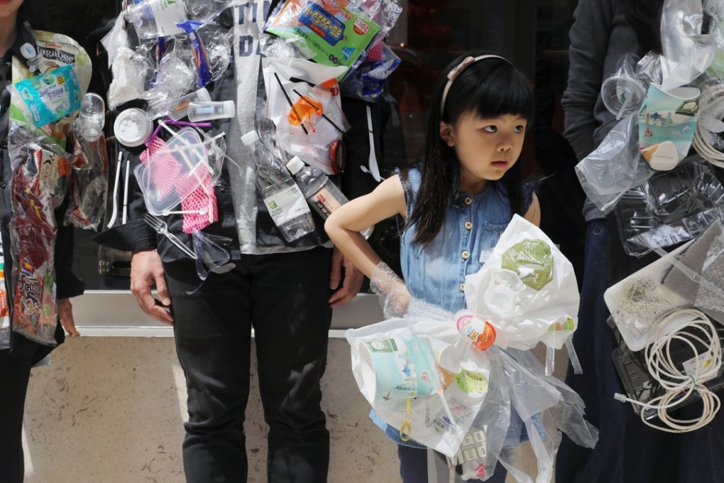 A young volunteer takes part in a drive for a plastic-free future, to mark International Earth Day, in Wan Chai on April 22. Photo: Sam Tsang