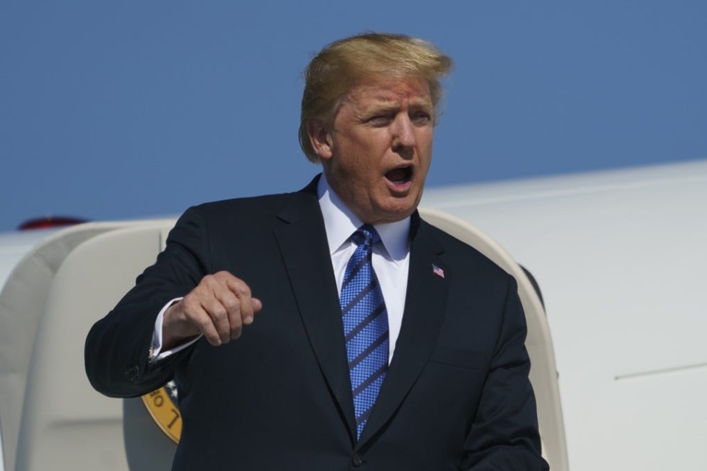 President Donald Trump calls out as he arrives on Air Force One at Morristown Municipal Airport on Friday. Photo: AP