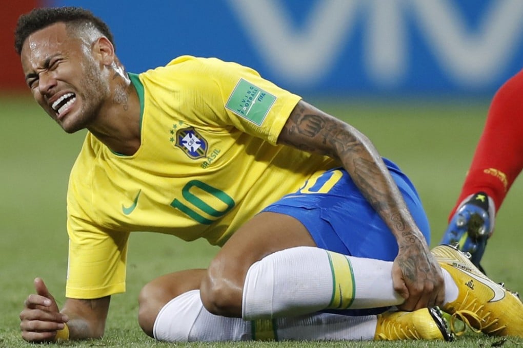 Brazil’s Neymar holds his leg during the World Cup quarter-final against Belgium. Photo: AP