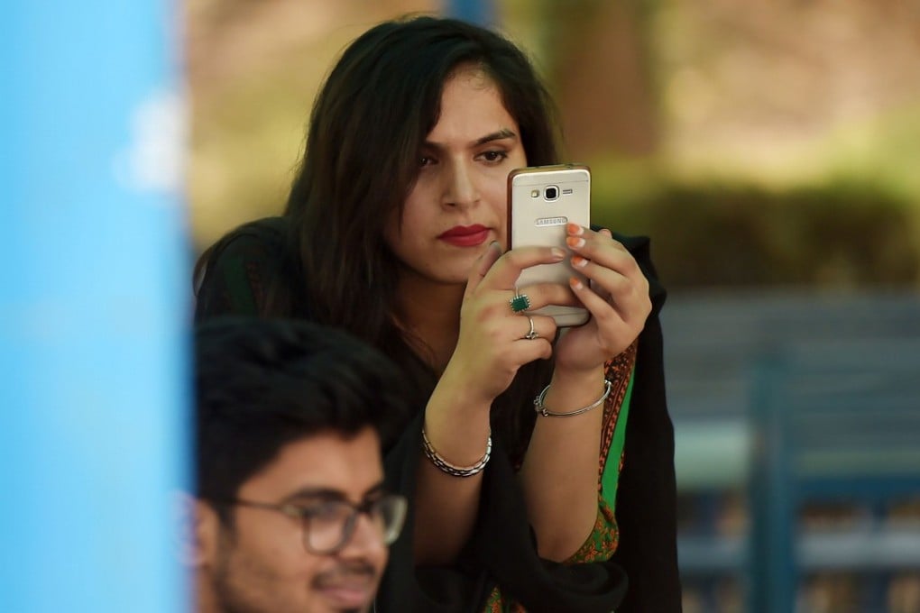 A student uses her mobile phone at a campus in Islamabad. Photo: AFP