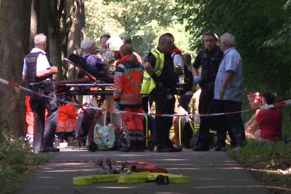 Firefighters attend passengers of a bus in Luebeck, northern Germany, on Friday after a man attacked people inside. Photo: TNN/dpa via AP
