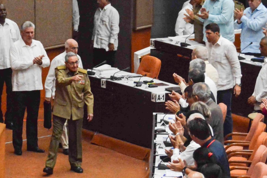 Cuba’s President Miguel Diaz-Canel (second left) applauds as former president Raul Castro arrives at the National Assembly session on July 21, 2018. Photo: AFP