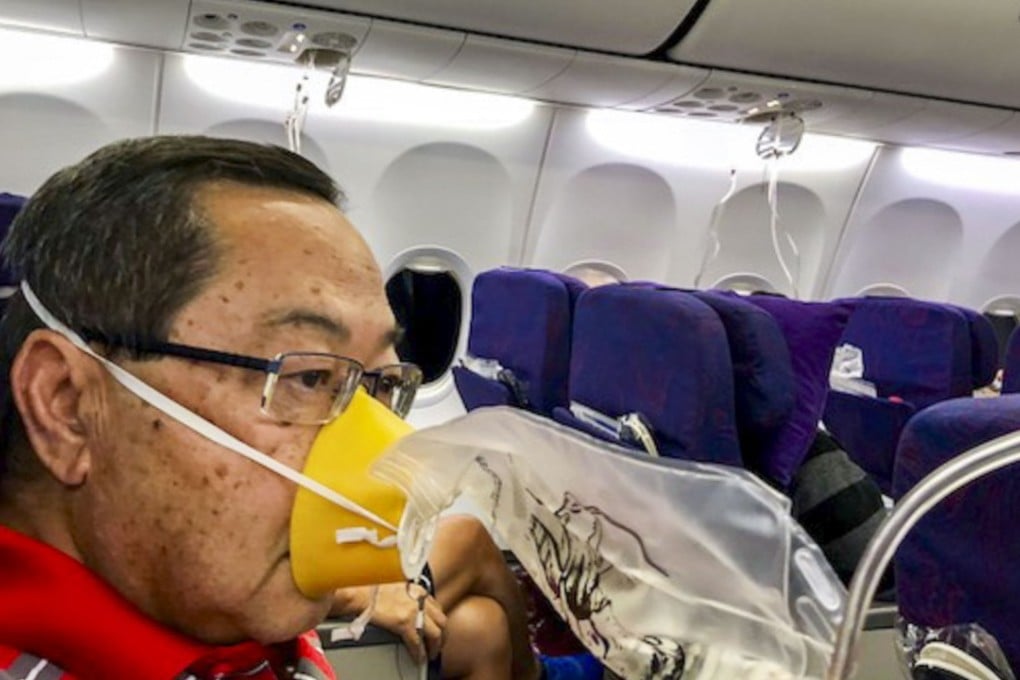 Passengers on Air China flight CA106 from Hong Kong to Dalian put on oxygen masks. Photo: Eugene Chow