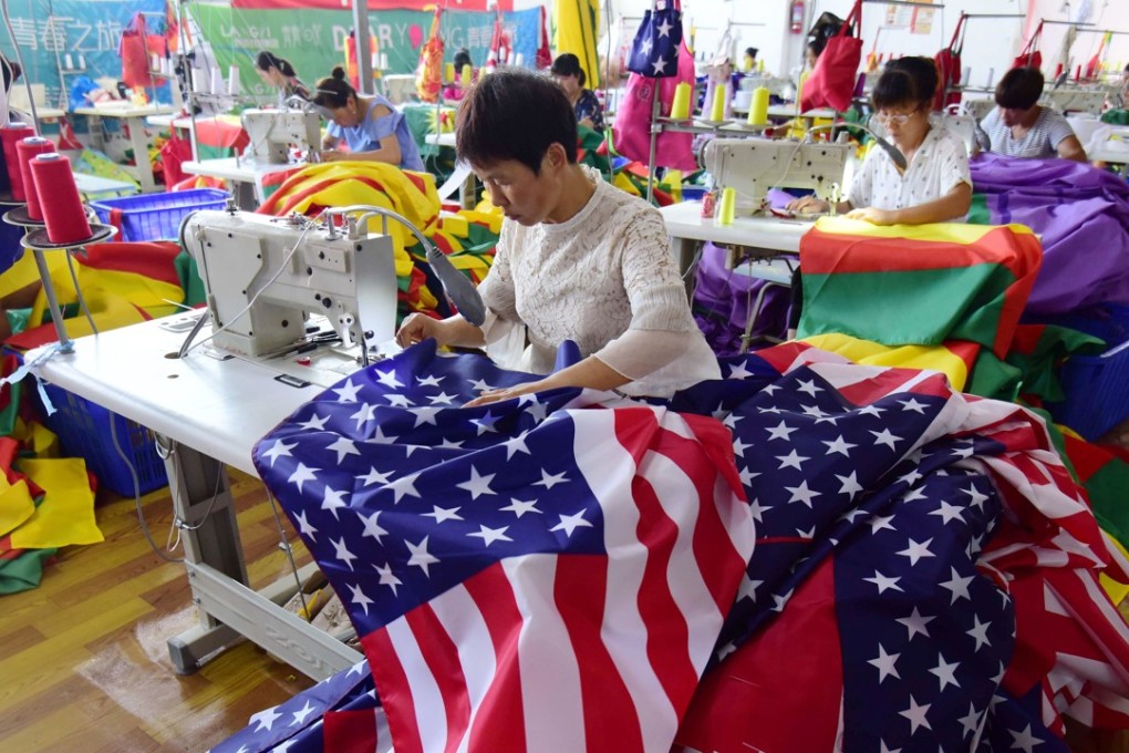 Chinese employees sew US flags at a factory in Fuyang in China’s eastern Anhui province on July 13. As the Sino-US trade war rages, China’s economy is being increasingly squeezed. Photo: AFP