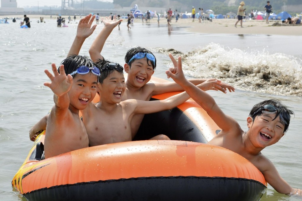 Children play at a beach in Soma, Fukushima Prefecture, which was reopened for the first time since the 2011 earthquake and tsunami. Photo: Kyodo