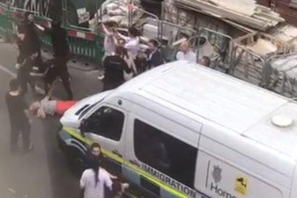 A woman (left, in red trousers) is seen on Gerrard Street in Chinatown during a July 5 immigration raid. Photo: YouTube / Ho Yikyee
