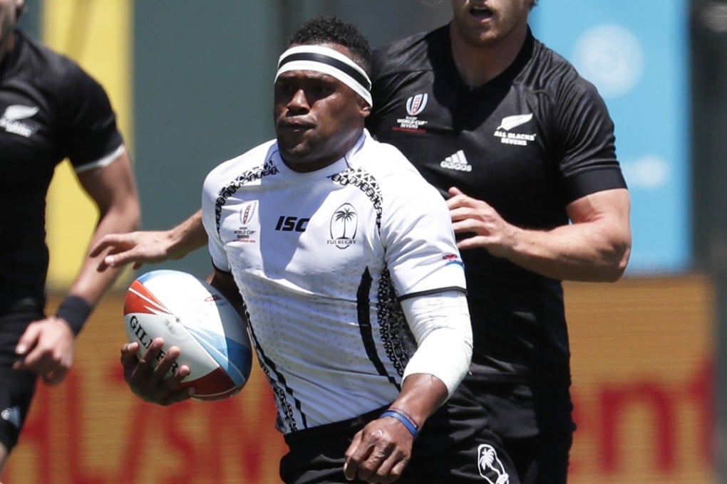 Amenoni Nasilasila streaks away for Fiji. Photo: EPA