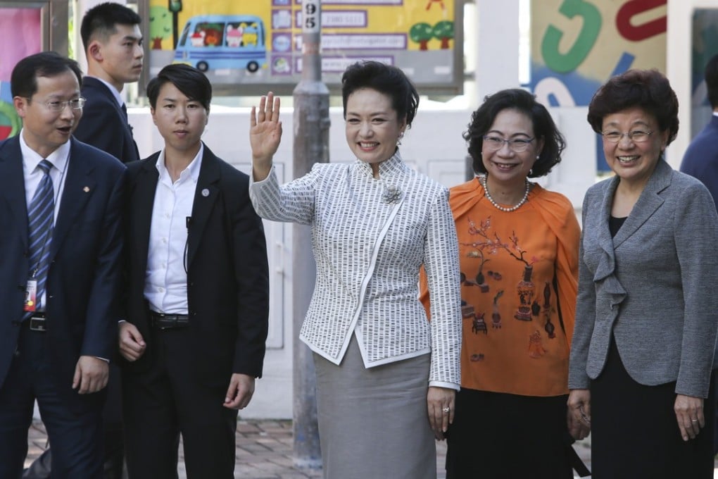 China’s first lady Peng Liyuan (centre), accompanied on her left by Yin Xiaojing (in grey), deputy director of Beijing’s liaison office in Hong Kong and Regina Leung Tong Ching-yee (in orange), wife of former chief executive Leung Chun-ying. Photo: Sam Tsang