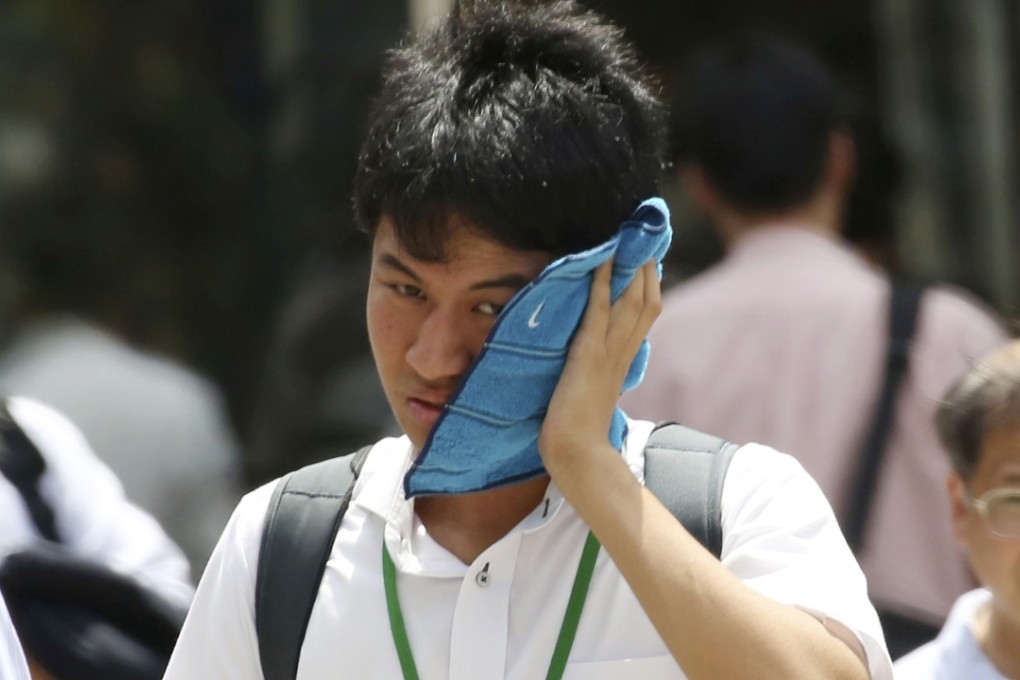 A man wipes the sweat from his face in the scorching heat in Tokyo. Photo: AP