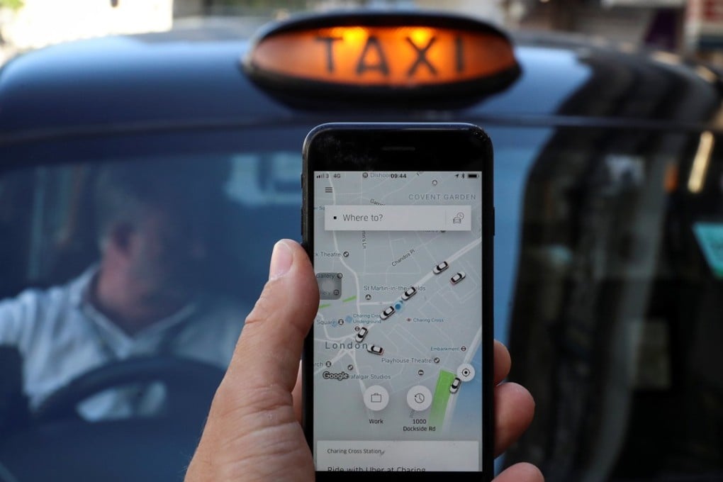 File photo of a phone with the Uber app and a black cab in London, Britain. Photo: Reuters