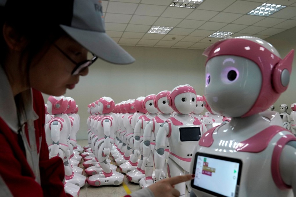 A worker puts finishing touches to an iPal social robot, designed by AvatarMind, at an assembly plant in Suzhou, Jiangsu province, China July 4, 2018. Photo: Reuters