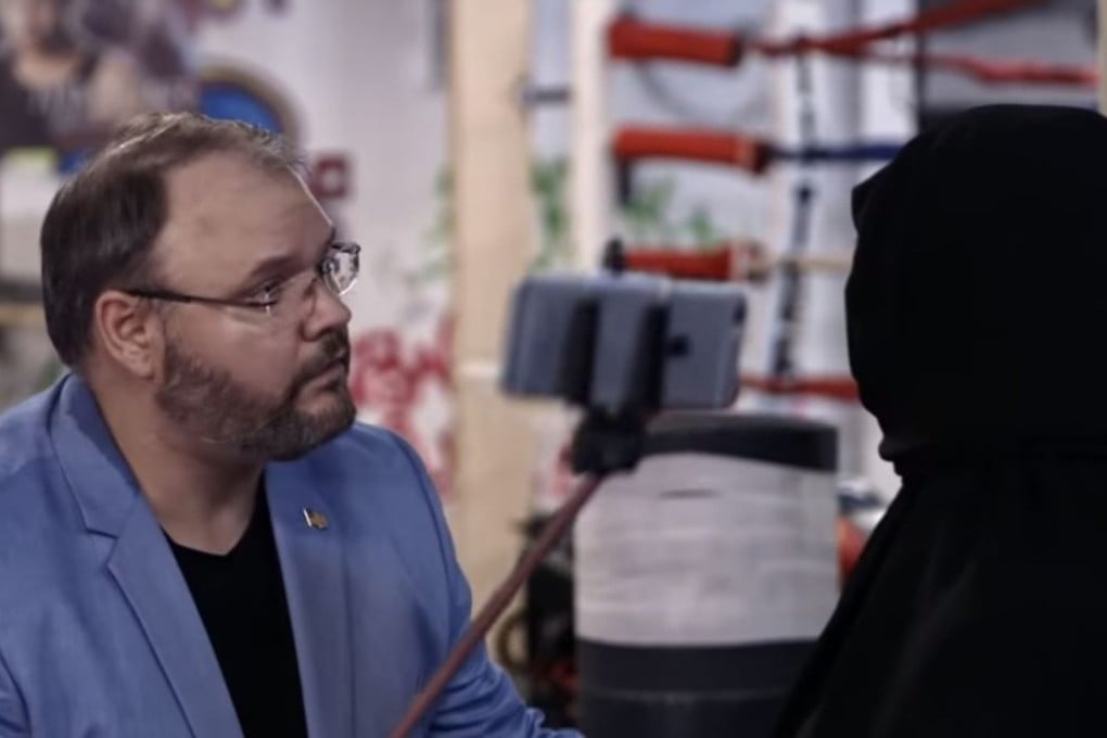 Georgia lawmaker Jason Spencer offered an offensive portrayal of a “Chinese tourist” while using a selfie-stick to take pictures up a Muslim actor’s robe to check for a gun. Photo: YouTube