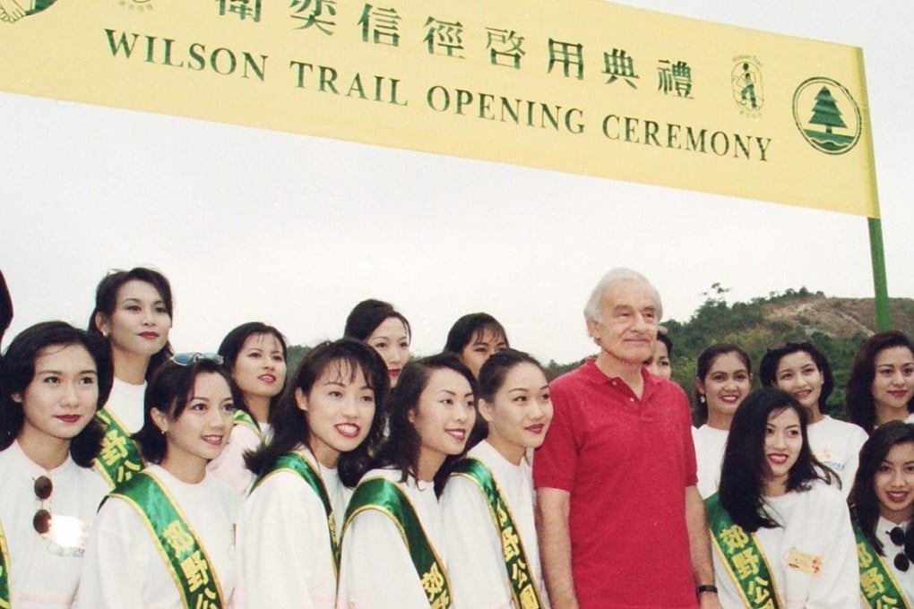 David Wilson poses for a picture with the contestants in the Miss Chinese International beauty pageant during the opening ceremony of the Wilson Trail at the Kam Shan Country Park. Photo: SCMP Pictures
