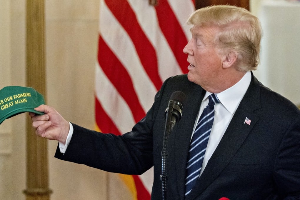 US President Donald Trump displays a ‘Make Our Farmers Great Again’ cap at the White House on Monday. Photo: Bloomberg