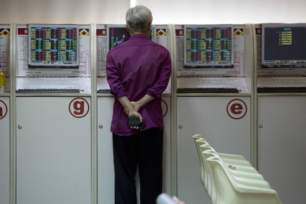 An investor monitors stock prices at a brokerage in Beijing. Chinese shares stabilised as government support for the economy boosted sentiment. Photo: AP