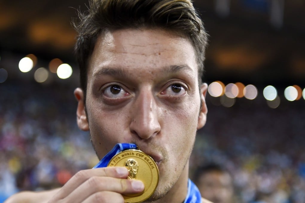 Mesut Ozil kisses his medal after Germany’s 2014 World Cup final win against Argentina. Photo: AFP