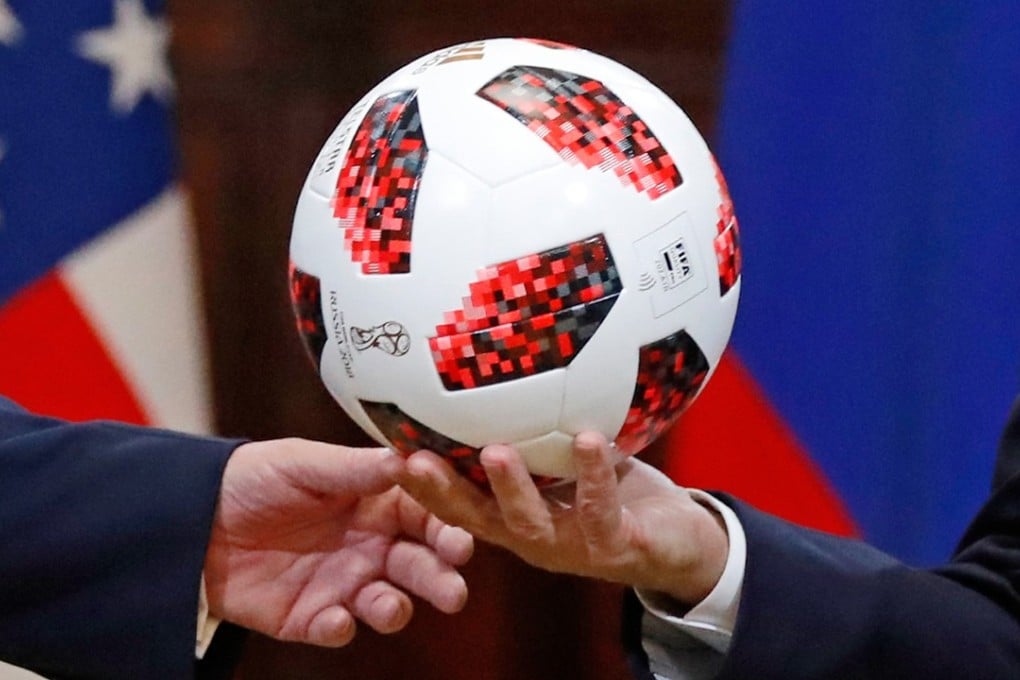 Russian President Vladimir Putin, right, gives a soccer ball to US President Donald Trump during a press conference after their meeting at the Presidential Palace in Helsinki, Finland, on July 16. Photo: AP
