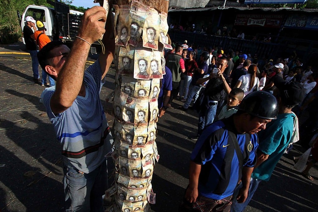 Virtually worthless Venezuelan banknotes plaster a lamp post during an earlier bout of hyperinflation in 2016. Inflation has now hit 1,000,000 per cent in the struggling South American country. Photo: Agence France-Presse
