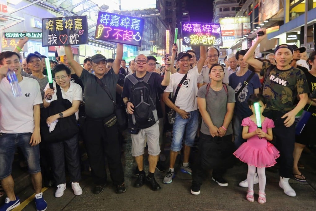 The audience enjoys a performance on Sai Yeung Choi Street South. Photo: Dickson Lee
