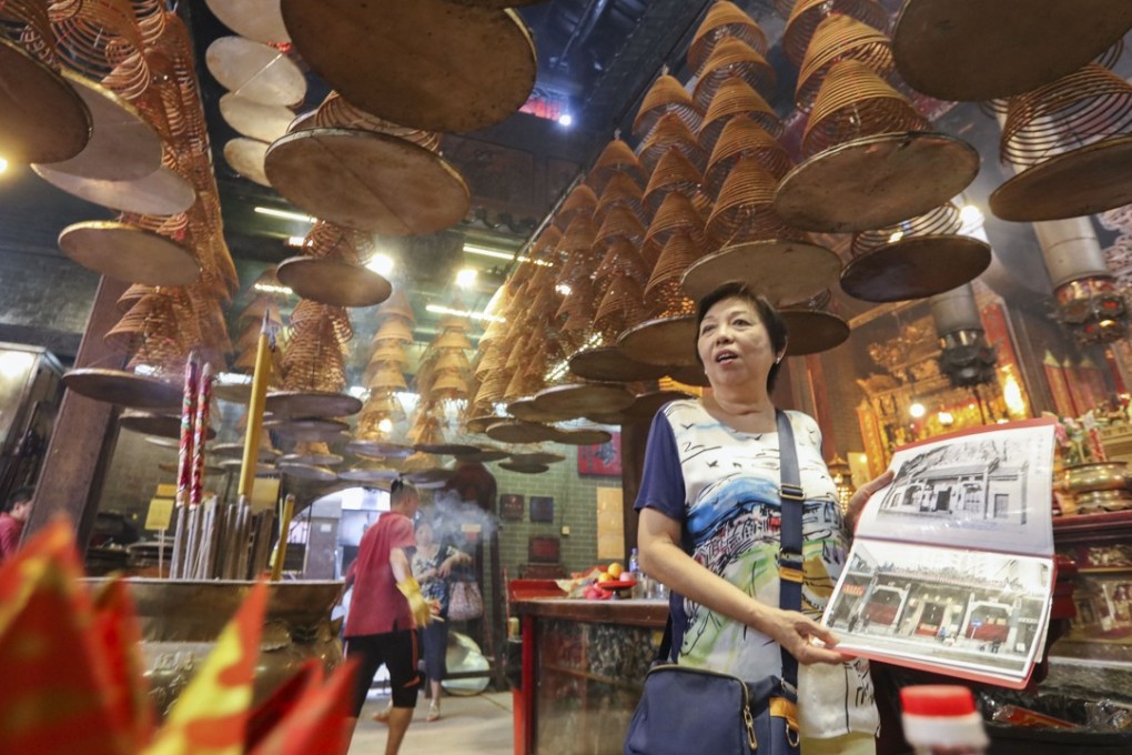 Leung King-foon, 69, visits a temple during a walking tour of Hung Hom. Photo: Felix Wong