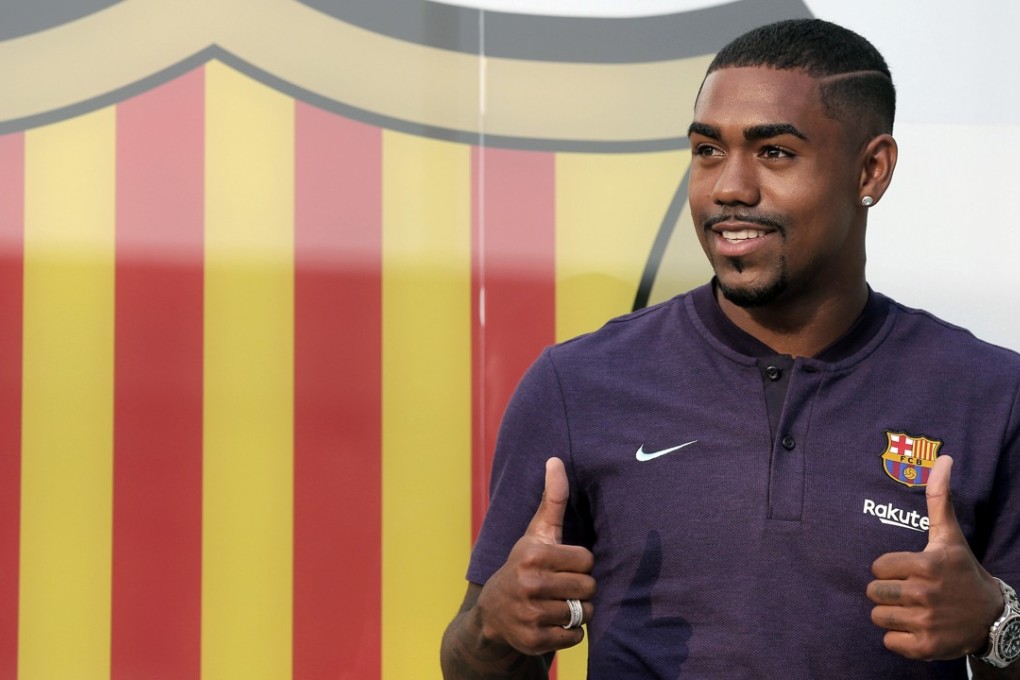 Brazilian player Malcom Filipe Silva de Oliveira poses for the media upon his arrival at Barcelona. Photo: AP