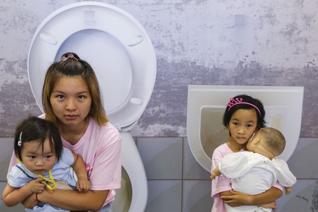 Moon Leung (left) with her two-year-old daughter Janice Fu (left bottom) and Galatea Ma Sze-Lok (right), 7, at the exhibition in Causeway Bay. Photo: Dickson Lee