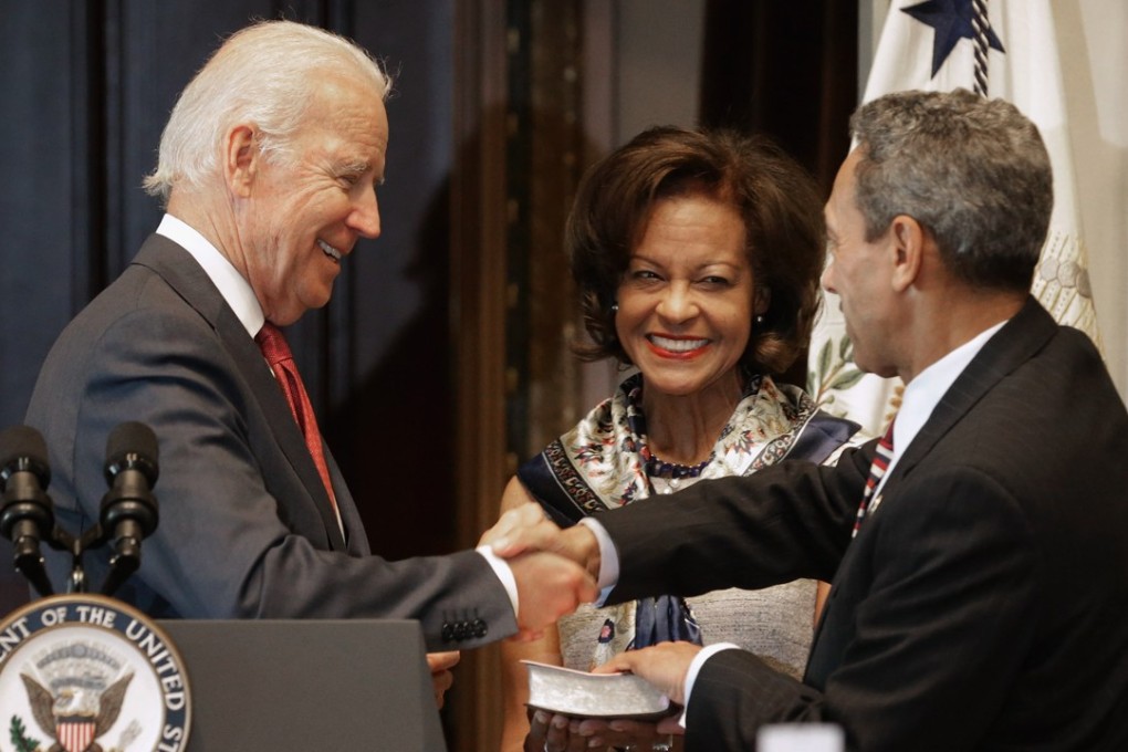 US Vice-President Joe Biden (left) ceremonially swears in Mel Watt (right) as the new director of the Federal Housing Finance Agency while Watt’s wife, Eulada, looks on in January 2014. Photo: Getty Images via AFP